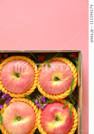 beautiful apple in the box on pink backgrond, healthy fruit beautiful apple in the box on pink backgrond, healthy fruit 111594274