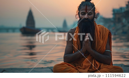 An old yogi was meditating on the bank of the Ganges River. It was quiet amidst the morning sunshine. Behind him is the view of Varanasi. It is a symbol of peace, tranquility and faith in Hinduism. 111594622