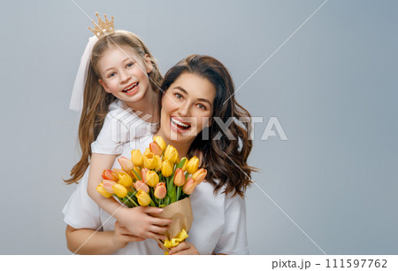 Daughter and mother with bouquet of flowers 111597762