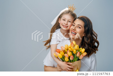 Daughter and mother with bouquet of flowers Daughter and mother with bouquet of flowers 111597763