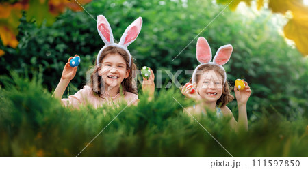 children with painting eggs outdoors children with painting eggs outdoors 111597850