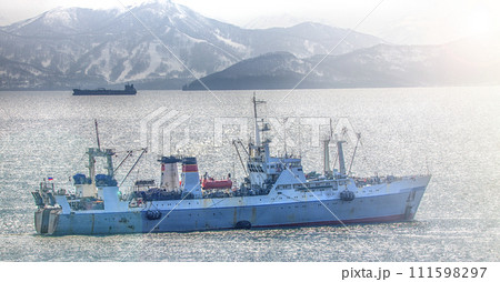 Fishing seiner on ocean near the coast of the Kamchatka peninsula on soft sunlight 111598297