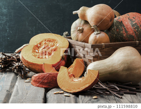 Ripe pumpkins on a wooden table. Ingredients for vegetarian soup. Thanksgiving. Halloween. Ripe pumpkins on a wooden table. Ingredients for vegetarian soup. Thanksgiving. Halloween. 111598810