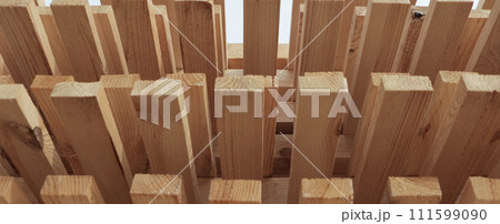 Stacks of pine lumber. Edged board. Wood harvesting workshop. Close-up of wooden planks. A narrow banner. 111599090