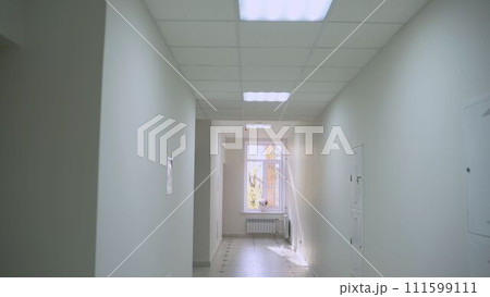 Empty corridor of a modern hospital. White corridor of a modern company. White corridor with doors in a modern hospital. Empty corridor of a modern hospital. White corridor of a modern company. White corridor with doors in a modern hospital. 111599111