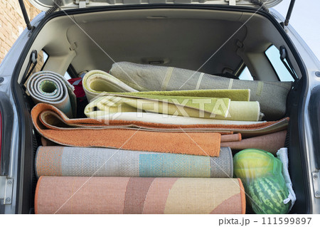Washed and dried rugs and carpets in the cars trunk 111599897