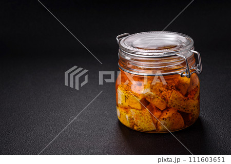 Delicious soft white feta cheese with salt, spices and herbs on a dark concrete background Delicious soft white feta cheese with salt, spices and herbs on a dark concrete background 111603651