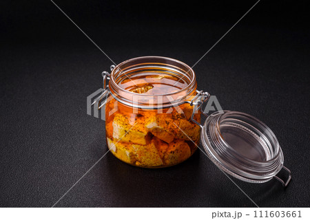 Delicious soft white feta cheese with salt, spices and herbs on a dark concrete background 111603661