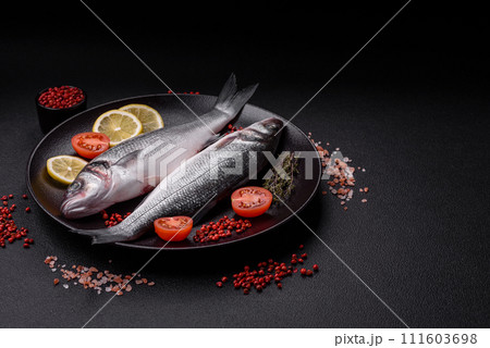 Fresh raw ocean sea bass fish with salt, spices and herbs 111603698