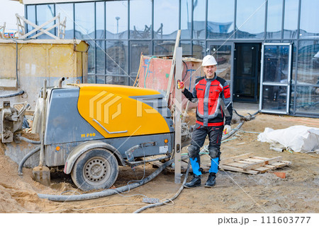 A builder in work clothes is doing his job A builder in work clothes is doing his job 111603777