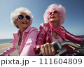 Portrait of an mature couple of women in pink clothes on a motorcycle valentine's Day concept 111604809