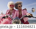 Portrait of an mature couple of women in pink clothes on a motorcycle valentine's Day concept 111604821