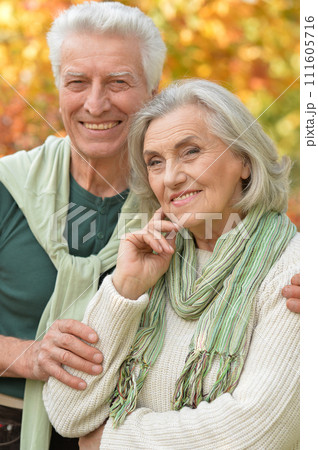 Portrait of happy senior couple in autumn park 111605716