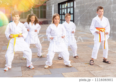 Kids in kimono doing kata moves Kids in kimono doing kata moves 111606901