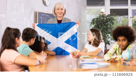 students listen to woman teacher who talks about Scotland students listen to woman teacher who talks about Scotland 111606928
