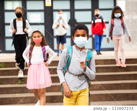 African american tween schoolboy in protective mask going to school 111607233