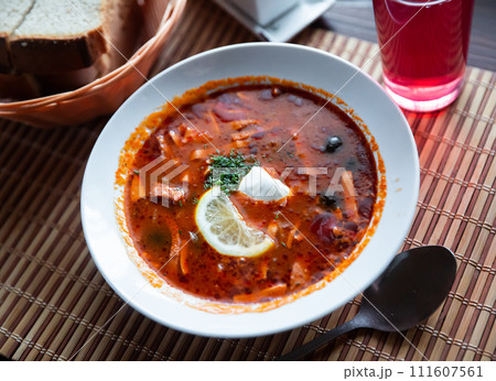Traditional Russian meat soup Solyanka with sour cream and lemon Traditional Russian meat soup Solyanka with sour cream and lemon 111607561