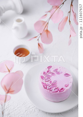 Piece of chocolate cake with pink cream and tea Piece of chocolate cake with pink cream and tea 111607657