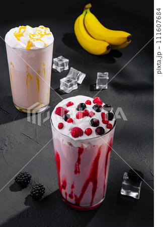 Delicious milkshakes on black stone with ice cubes 111607684