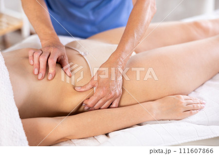 Elderly woman doing waist massage to young woman 111607866