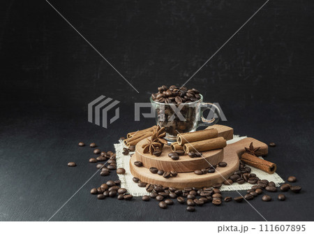 Winter hot drink. Christmas.coffee on a black background, delicious coffee beans ,morning coffee. Winter hot drink. Christmas.coffee on a black background, delicious coffee beans ,morning coffee. 111607895