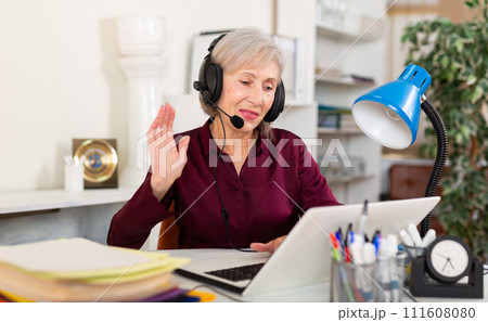 Woman in earphones working at office 111608080