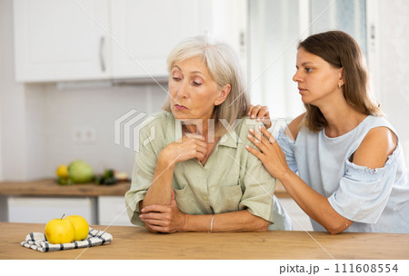 Woman consoling her depressed elderly mother Woman consoling her depressed elderly mother 111608554