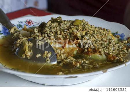 Lontong Kupang, a traditional Indonesian soup made with steamed rice cakes and small mussels. 111608583