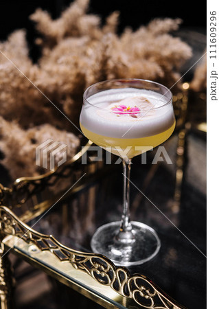 Glass with yellow lemon cocktail with foam Glass with yellow lemon cocktail with foam 111609296