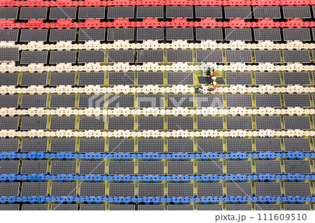 Top view and wide shot of two technician workers set up or install solar cell panel over the water reservoir as solar farm factory in concept of green energy for good environment. 111609510