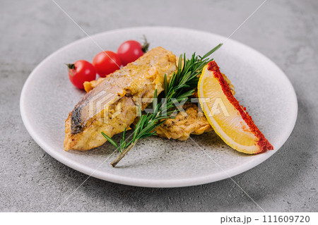 grilled fish steak and vegetables on a plate 111609720