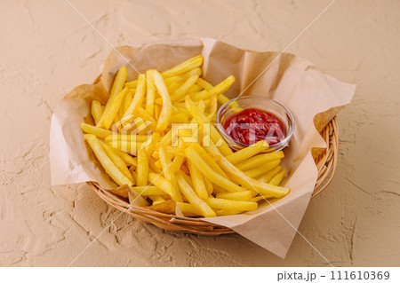 French Fries with Ketchup in Basket 111610369