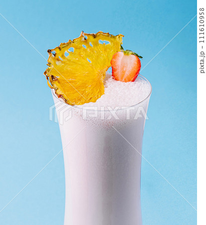 glass cup of milkshake with dry pineapple and strawberries 111610958