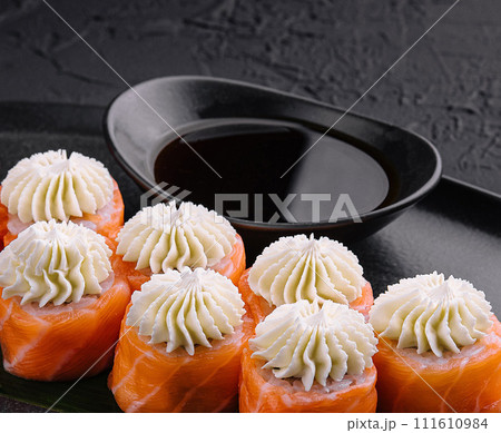 Philadelphia Sushi with Philadelphia Cheese on Black Asian Plate 111610984