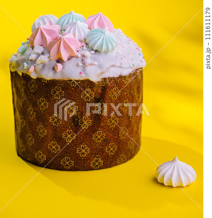 Traditional Easter cakes with meringue on yellow background Traditional Easter cakes with meringue on yellow background 111611179