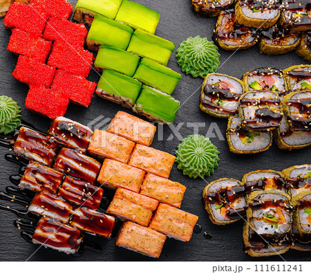 Large sushi set, shot from the top on a black background Large sushi set, shot from the top on a black background 111611241