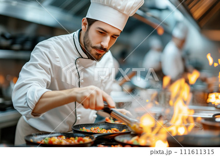 Chef cooking with flame in professional kitchen 111611315