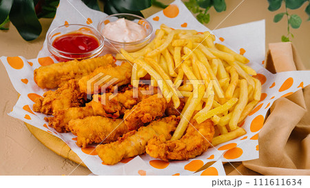 french fries with chicken nuggets and sauces 111611634