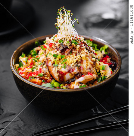 Salad with eel and couscous on black bowl Salad with eel and couscous on black bowl 111611639