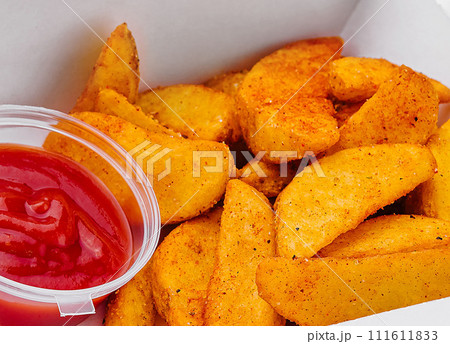 Fried potato wedges in takeaway box Fried potato wedges in takeaway box 111611833