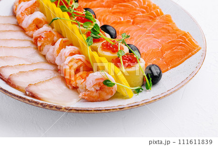 salmon, white fish, shrimp and red caviar on plate 111611839