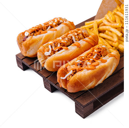 Hot dogs and fried potatoes on wooden board Hot dogs and fried potatoes on wooden board 111611931