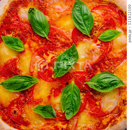 Margherita Pizza with Basil close up background Margherita Pizza with Basil close up background 111612100