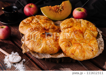 Cooking traditional pies with apple and pumpkin on wooden board 111612311
