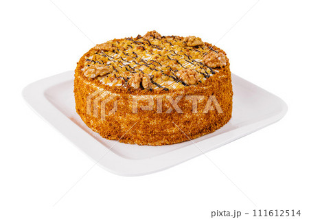 Cake with walnuts and honey on plate 111612514