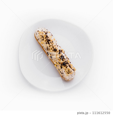Eclair with cream and chocolate on plate 111612550