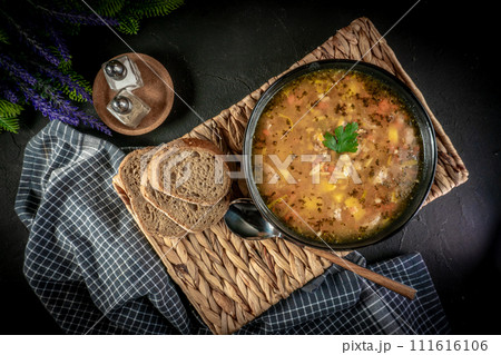 Pea soup with pieces of white sausage, potatoes and small dumplings. 111616106