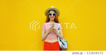 Summer portrait of happy traveler young woman 20s with mobile phone looking at device Summer portrait of happy traveler young woman 20s with mobile phone looking at device 111616172