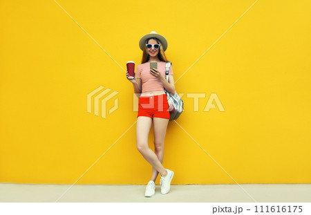Summer image of traveler young woman 20s with mobile phone looking at device Summer image of traveler young woman 20s with mobile phone looking at device 111616175