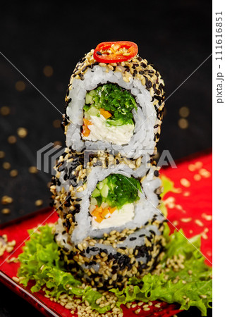 Stack of light vegetarian sushi rolls on red plate 111616851